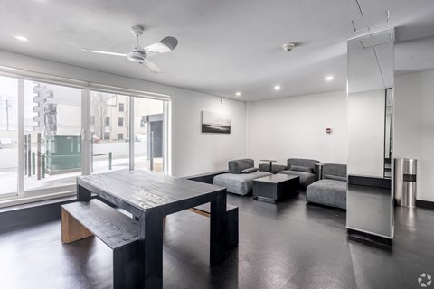 A room with a long table and chairs.