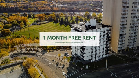 A large building with a sign offering a free one month rent.