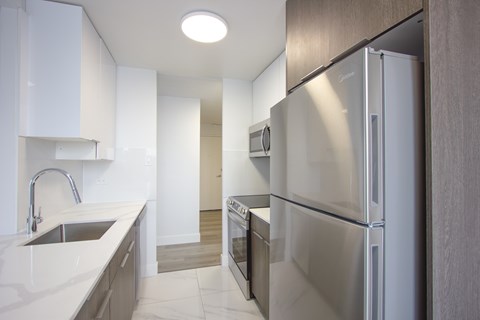 A modern kitchen with a stainless steel refrigerator.