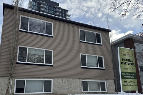 A sign for Lestown Burnbrae Apartments is displayed in front of a building.