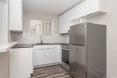 A modern kitchen with a stainless steel refrigerator.