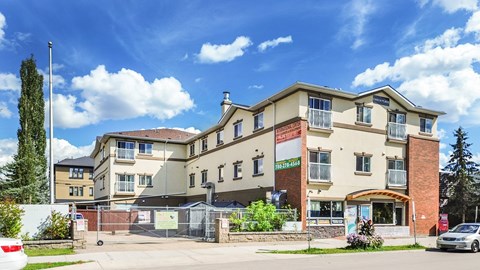 A large building with a sign that says "RESIDENCES" in front of it.