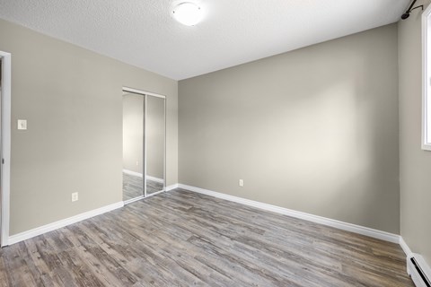 A room with a sliding door and wood flooring.