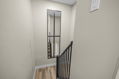 A mirror on the wall above a staircase.