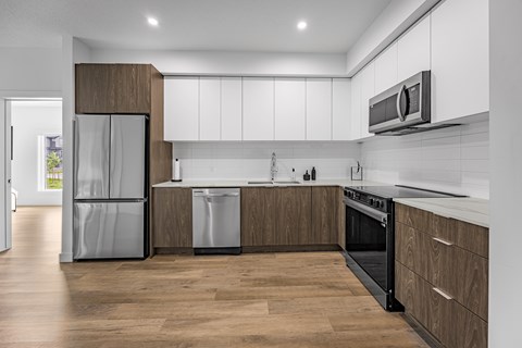 A modern kitchen with wooden cabinets and stainless steel appliances.