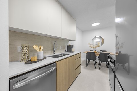 A modern kitchen with a dining table and chairs.