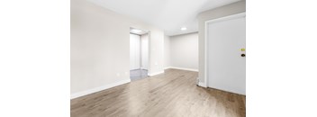 A room with a white door and a window with blinds.