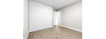 A room with a white door and a white wall.