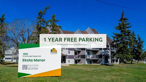 A sign advertising 1 year free parking in front of a building.
