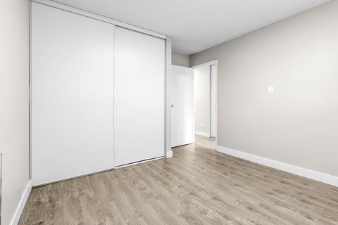 A room with a white door and a white wall.