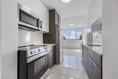 A modern kitchen with a white oven and microwave.
