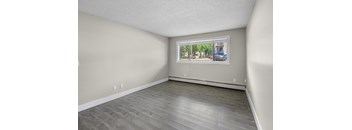 Empty room with a window showing a street view.