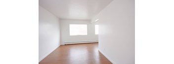 A room with wooden floors and a window.
