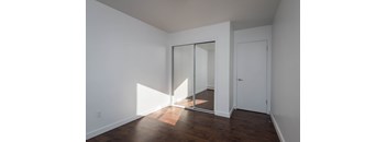 A room with a white door and a white wall.