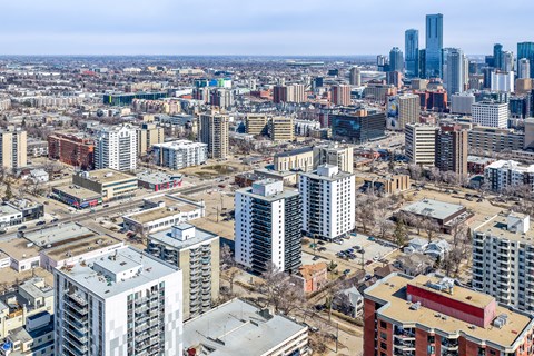 A cityscape with a mix of residential and commercial buildings.