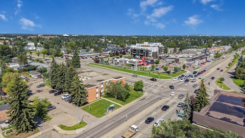 A busy intersection in a city with multiple lanes and traffic.