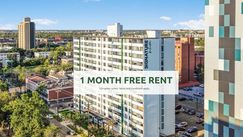 A tall building with a sign that reads "1 MONTH FREE RENT" in front of a cityscape.
