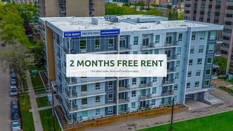 A modern apartment building offers a 2 months free rent promotion.