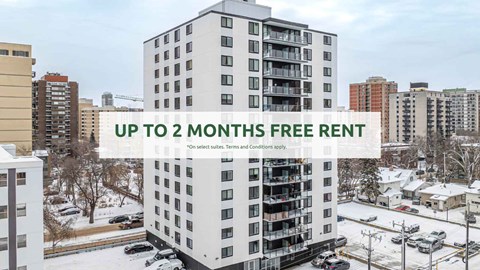 A tall white apartment building with a sign offering up to 2 months free rent.
