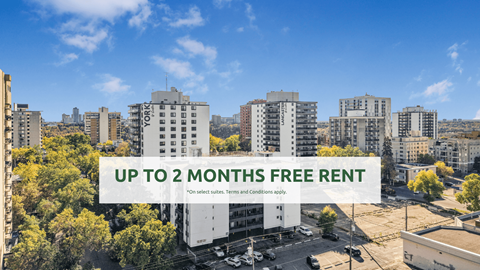 A cityscape with buildings and a sign offering up to 2 months free rent.
