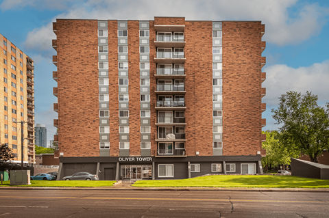 Oliver Tower is a tall brick building with many windows.