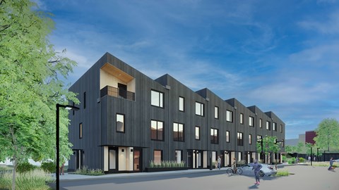 A modern building with a black facade and large windows at The Grove Apartments, Orillia