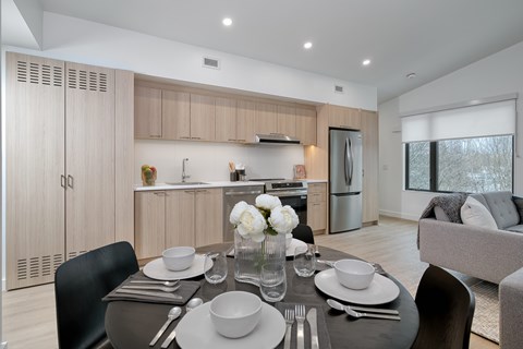 A modern dining room with a table set for two.