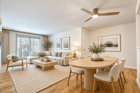 A living room with a round table and chairs.