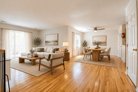 A living room with a couch, coffee table, and chairs.