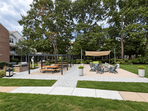 A park area with a picnic table and chairs.