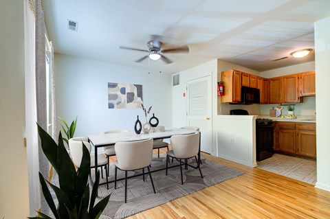 A dining room with a white table and chairs.