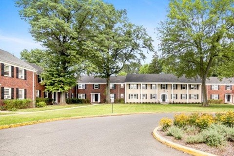 A large building with a parking lot in front.