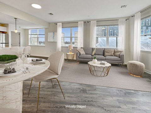 A virtual staging of a modern living room with a dining area.