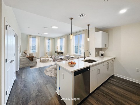 A kitchen with a dining table and chairs in front of a window.