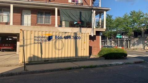 A building with a sign that says "mobile modular" and a phone number on it.