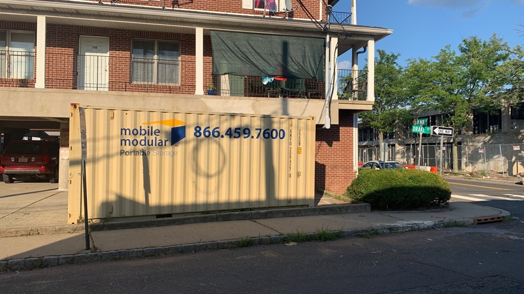 A building with a sign that says "mobile modular" and a phone number on it.