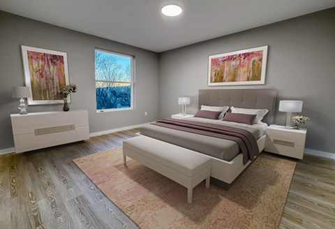 A bedroom with a large bed and a painting on the wall.