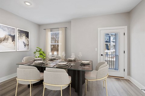 A dining room with a table set for four.