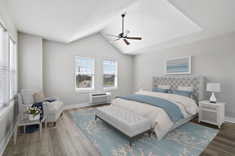 A bedroom with a large bed and a ceiling fan.