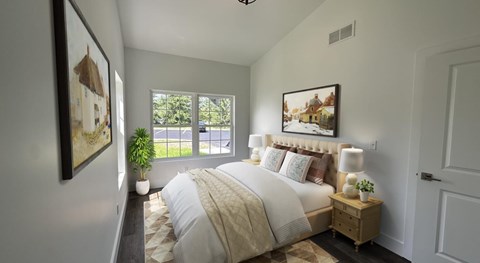 A bedroom with a large bed and a painting on the wall.