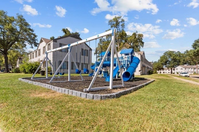 A playground with a blue slide and a white structure.