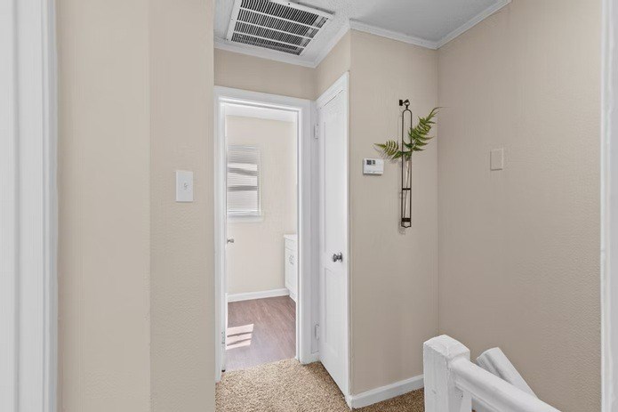 A white door is open to a hallway.