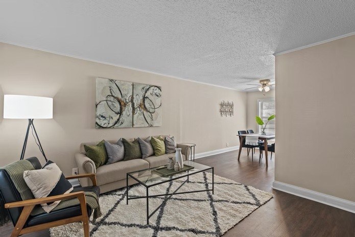 A living room with a couch, a chair, and a coffee table.
