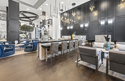 A modern dining room with a long table and chairs.
