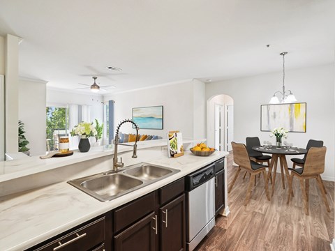 A modern kitchen with a dining table and chairs.