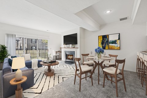 A living room with a fireplace, a painting, and a dining table set up.