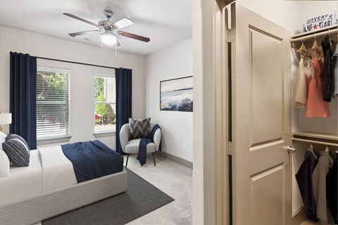 A bedroom with a bed, chair, and a wardrobe.