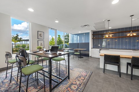 A modern dining room with a table set for four.