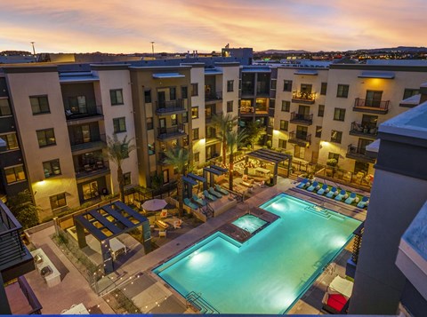 A swimming pool in a courtyard surrounded by apartment buildings.