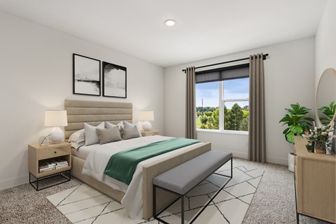 A bedroom with a large bed and a window with curtains.
